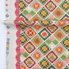 コットン生地 かぎ針編みのモチーフ柄(グリーンオレンジ) 10cm単位 切り売り